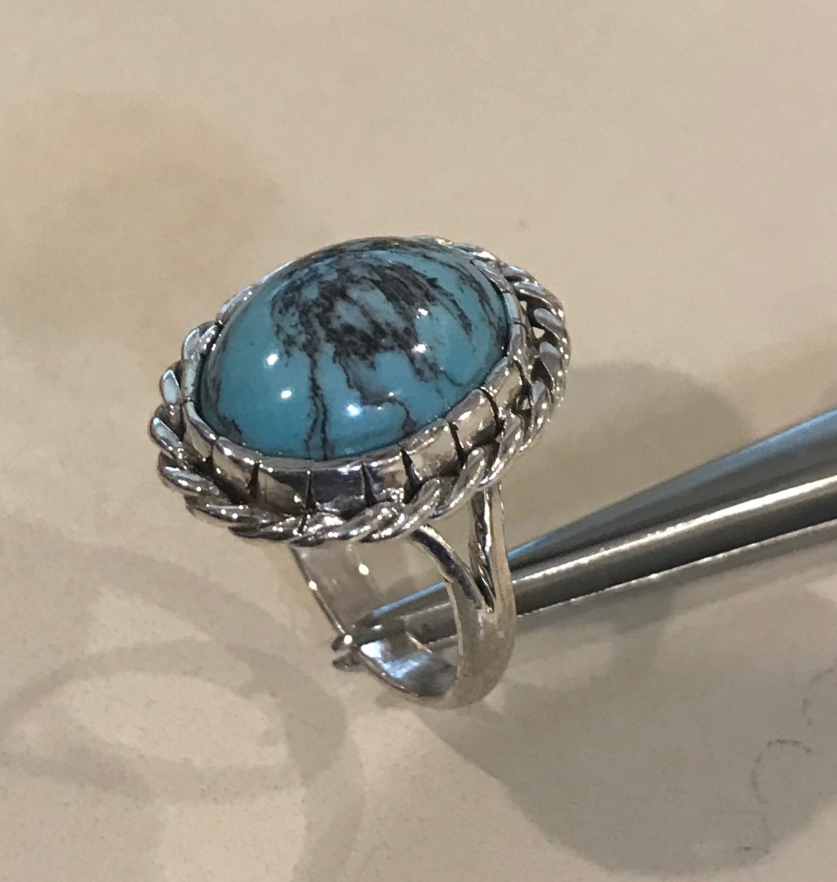  The bezel is further ornamented by the addition of the braided silver wire. 